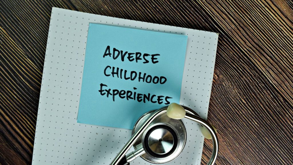 Adverse Childhood Experiences note with stethoscope on wooden desk