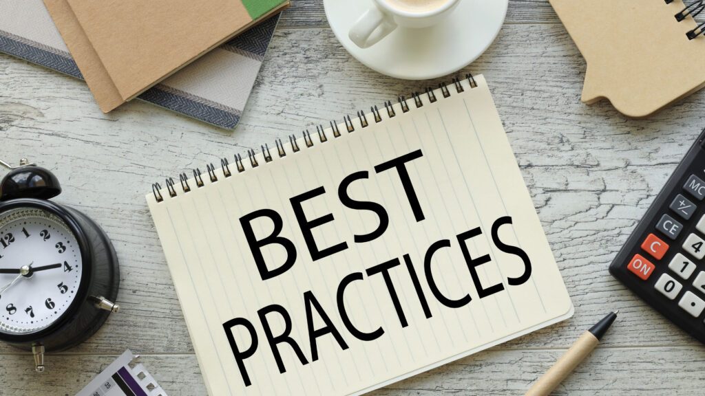 Notebook with 'Best Practices' on desk with office supplies