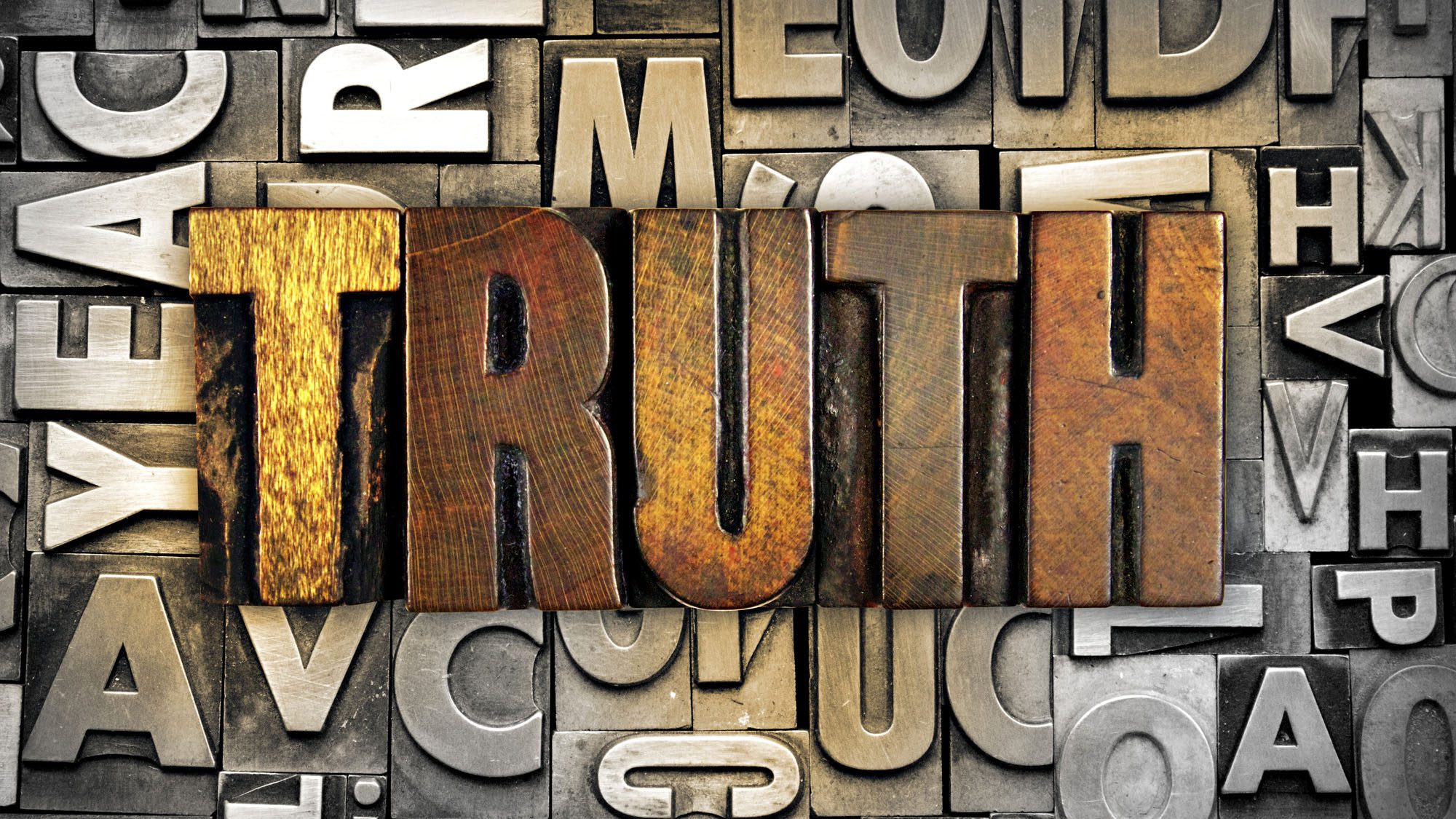 Vintage letterpress blocks spelling TRUTH in bold letters