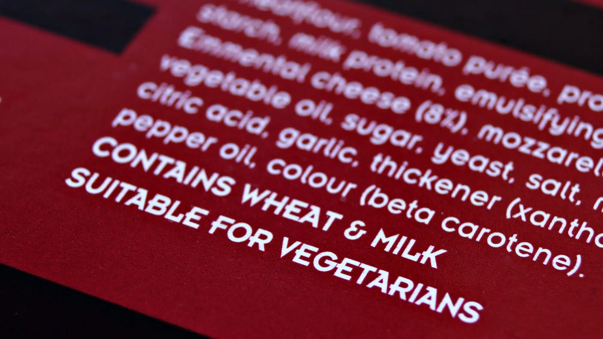 Close-up of food packaging label showing ingredients and dietary suitability
