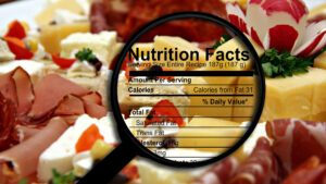 Magnified nutrition facts over assorted cheese and meats platter